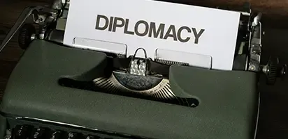 Vintage typewriter with "DIPLOMACY" typed on the paper.