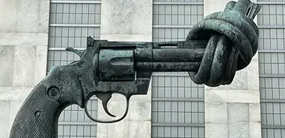 Statue of a revolver with the barrel tied into a knot.