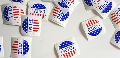 Stickers that read: "I Voted" scattered on a white surface.